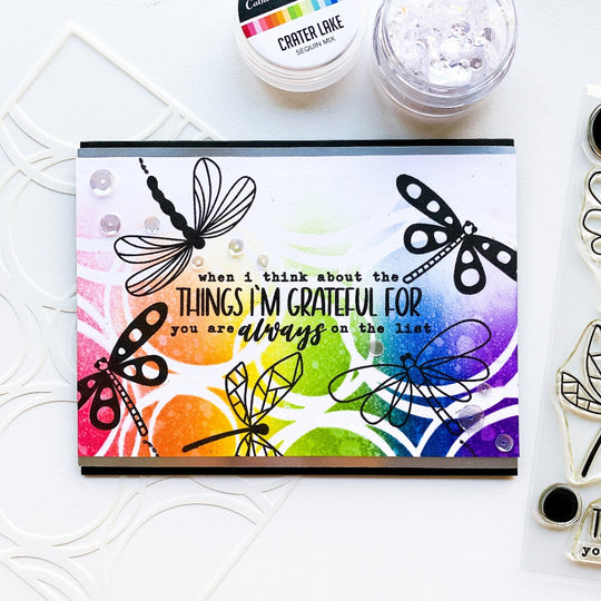card with dragonflies and scribbled circles background