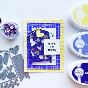 Hearts N Tags blue glitter cut out over patterned papers