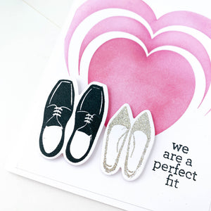 card with two pairs of shoes and heart