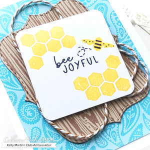 Bee Kind Stamp Set on wood grain background