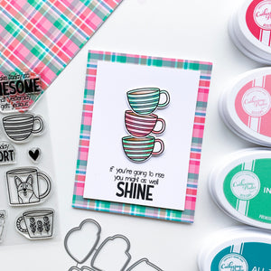 Three stacked striped mugs with plaid background