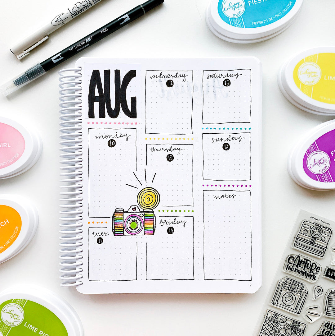 August weekly calendar in canvo journal with camera stamp