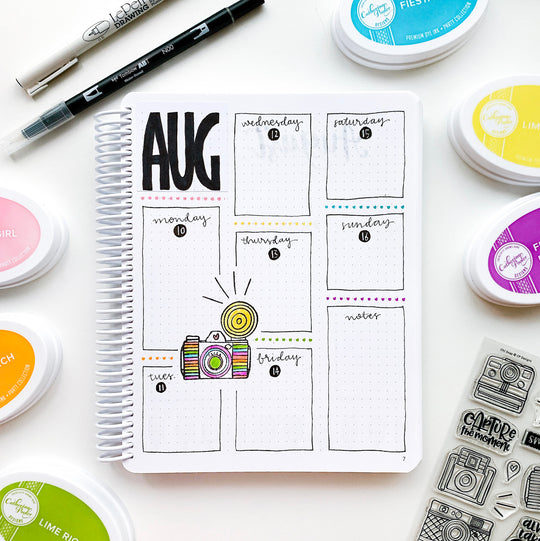 August weekly calendar in canvo journal with camera stamp