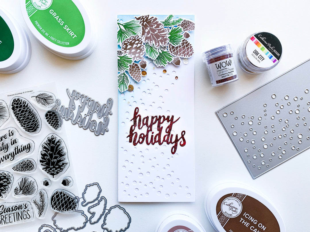 Pinecones layered over Flurries Slimline Background with Happy Holidays Senteiment