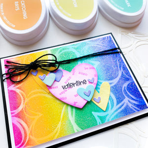 Scribbled Hearts rainbow glitter background with Hearts n Tags cut outs on top
