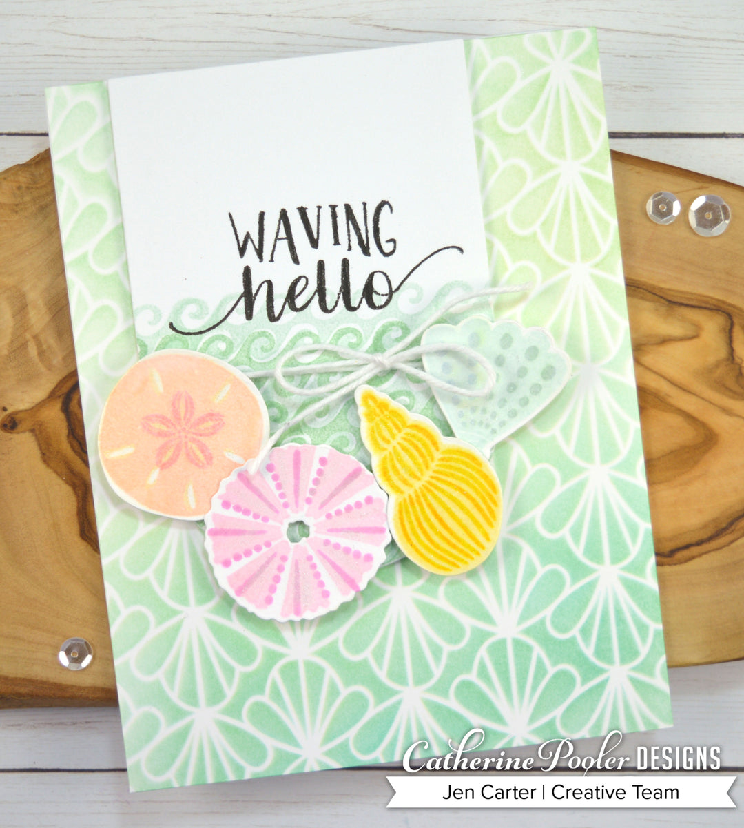 waving hello card with seashells