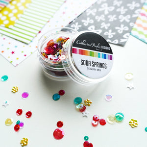 Soda Springs Sequin Mix next to patterned paper