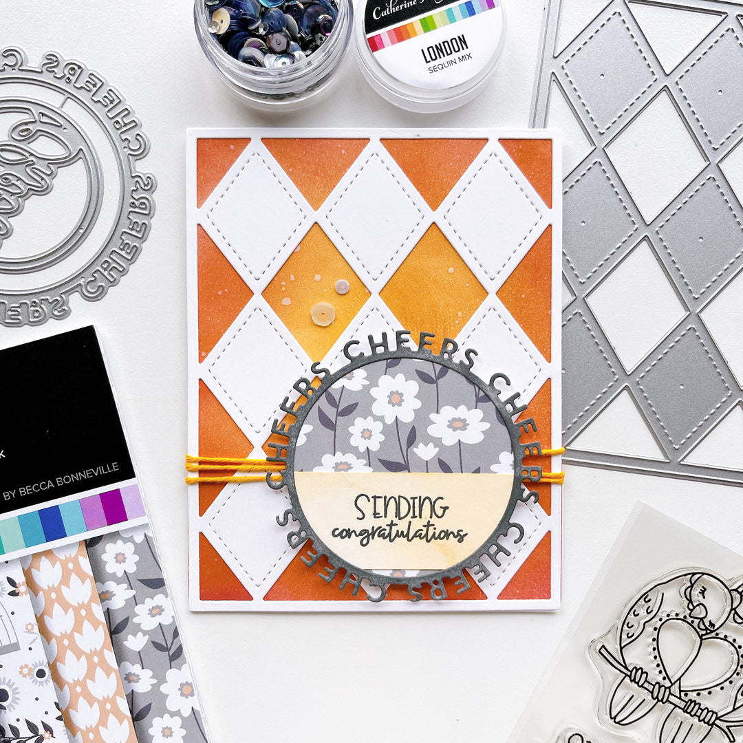 Sending Congrats card using Stitch your Diamonds cover plate die, Round of Cheers die, Twilight Reading patterned paper, Midnight, Twilight and Ginger ink pads and London sequin mix.