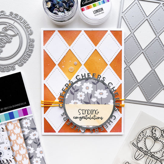 Sending Congrats card using Stitch your Diamonds cover plate die, Round of Cheers die, Twilight Reading patterned paper, Midnight, Twilight and Ginger ink pads and London sequin mix.