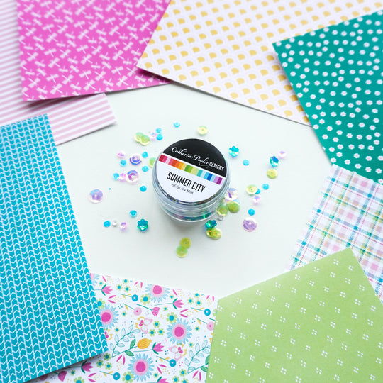 Summer City Sequin Mix next to patterned paper