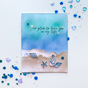 card with beach scene with topsail sequins